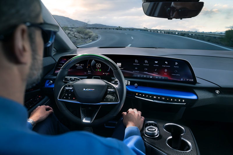 Front View of the 2026 OPTIQ-V Driving Through the Dusk Utilizing its Headlights | Carlisle Cadillac in Carlisle PA